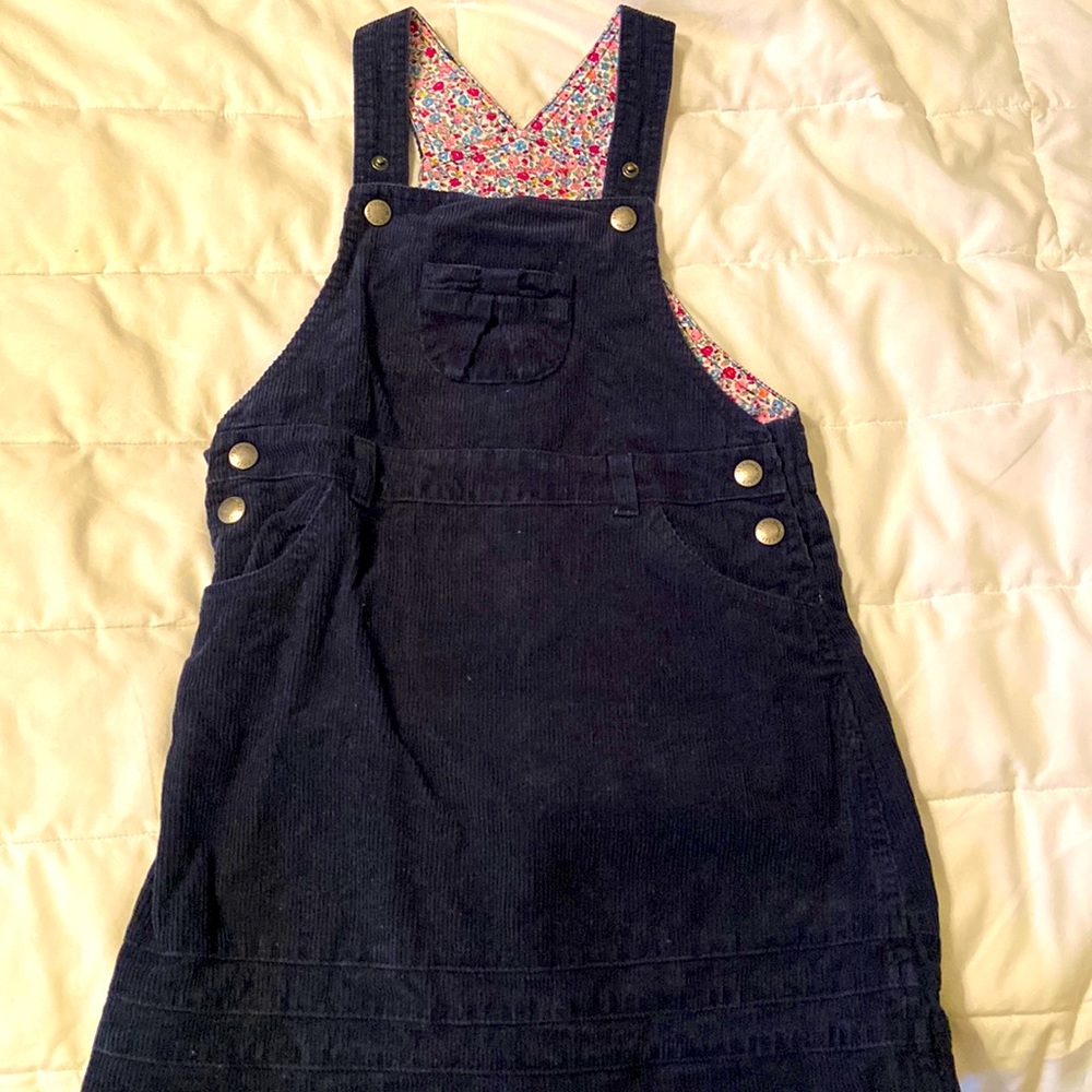 Size 5-6 JoJo Maman Bebe navy blue corduroy dress with floral interior pattern.